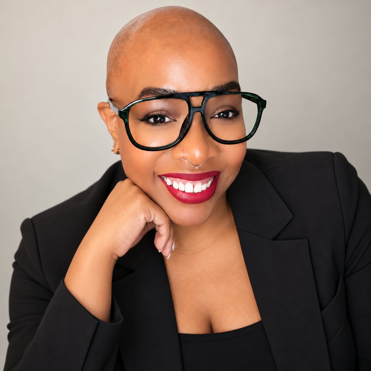 Sue A. Webley smiling in dark glasses and a black blazer
